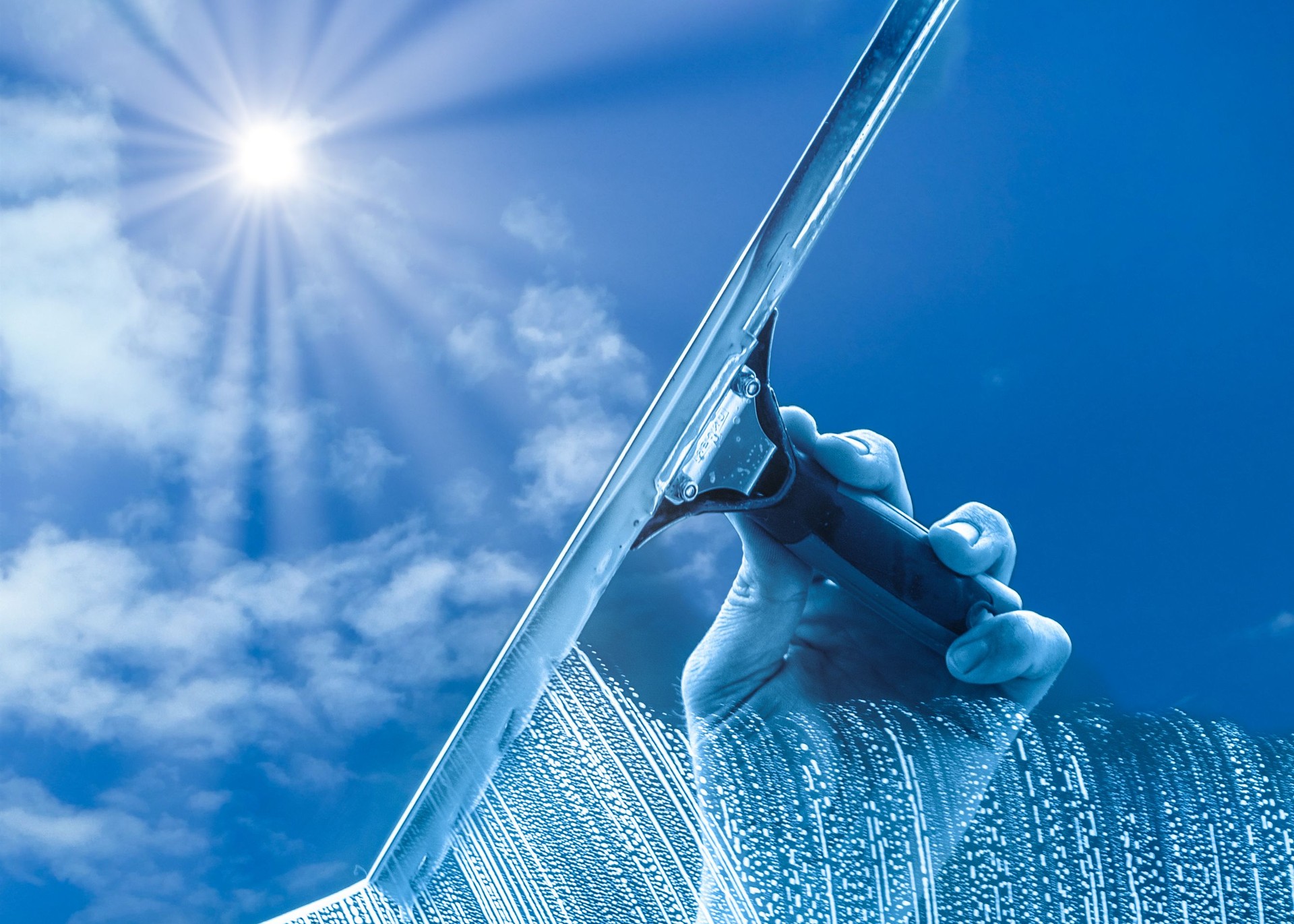 The window cleaner cleans the office windows